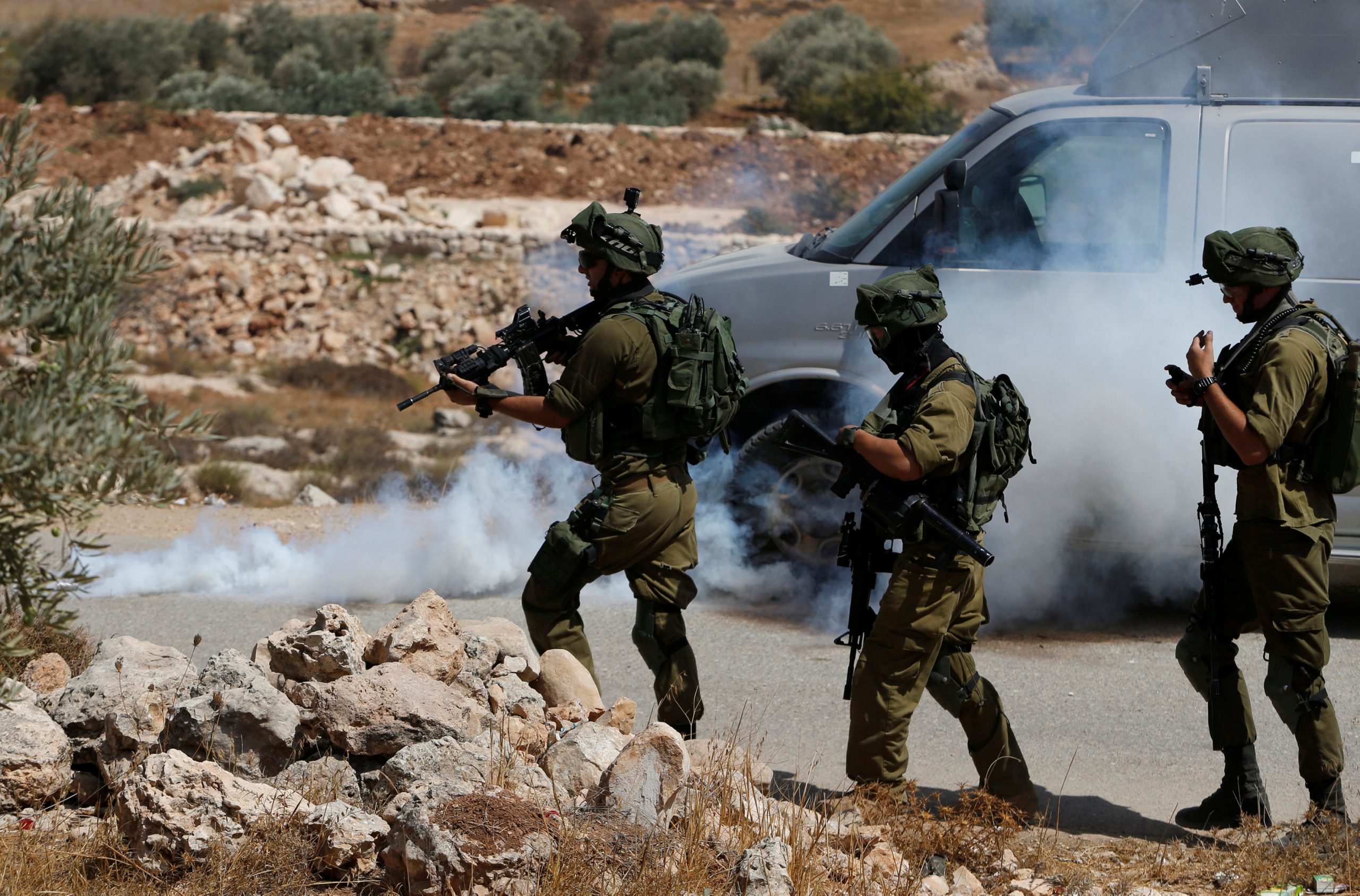 Israeli soldiers fire tear gas canisters at Palestinians during clashes following a protest against closure of a road south of the West Bank city of Hebron September 22, 2017. REUTERS/Mussa Qawasma