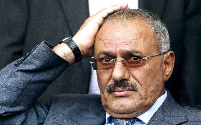 Yemeni President Ali Abdullah Saleh reacts while looking at his supporters, not pictured, during a rally supporting him, in Sanaa,Yemen, Friday, April 8, 2011. Tens of thousands of Yemenis have converged in the capital for rival demonstrations _ with some demanding the president's ouster and others showing their support. Police and army units were deployed Friday to prevent any friction between the two sides. (AP Photo/Muhammed Muheisen)