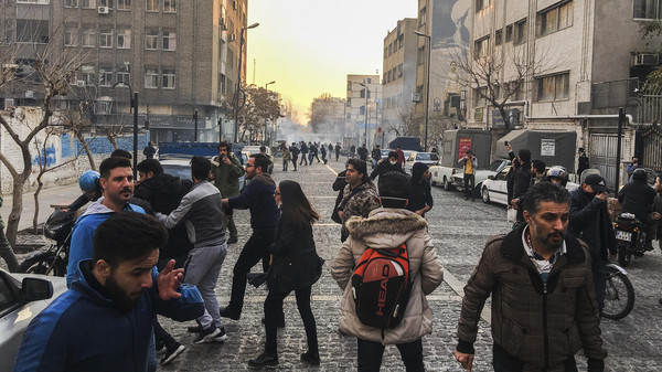 In this photo taken by an individual not employed by the Associated Press and obtained by the AP outside of Iran, people are affected by tear gas fired by anti-riot Iranian police to disperse demonstrators in a protest over Iran's weak economy, in Tehran, Iran, Saturday, Dec. 30, 2017. A wave of spontaneous protests over Iran's weak economy swept into Tehran on Saturday, with college students and others chanting against the government just hours after hard-liners held their own rally in support of the Islamic Republic's clerical establishment. (AP Photo)