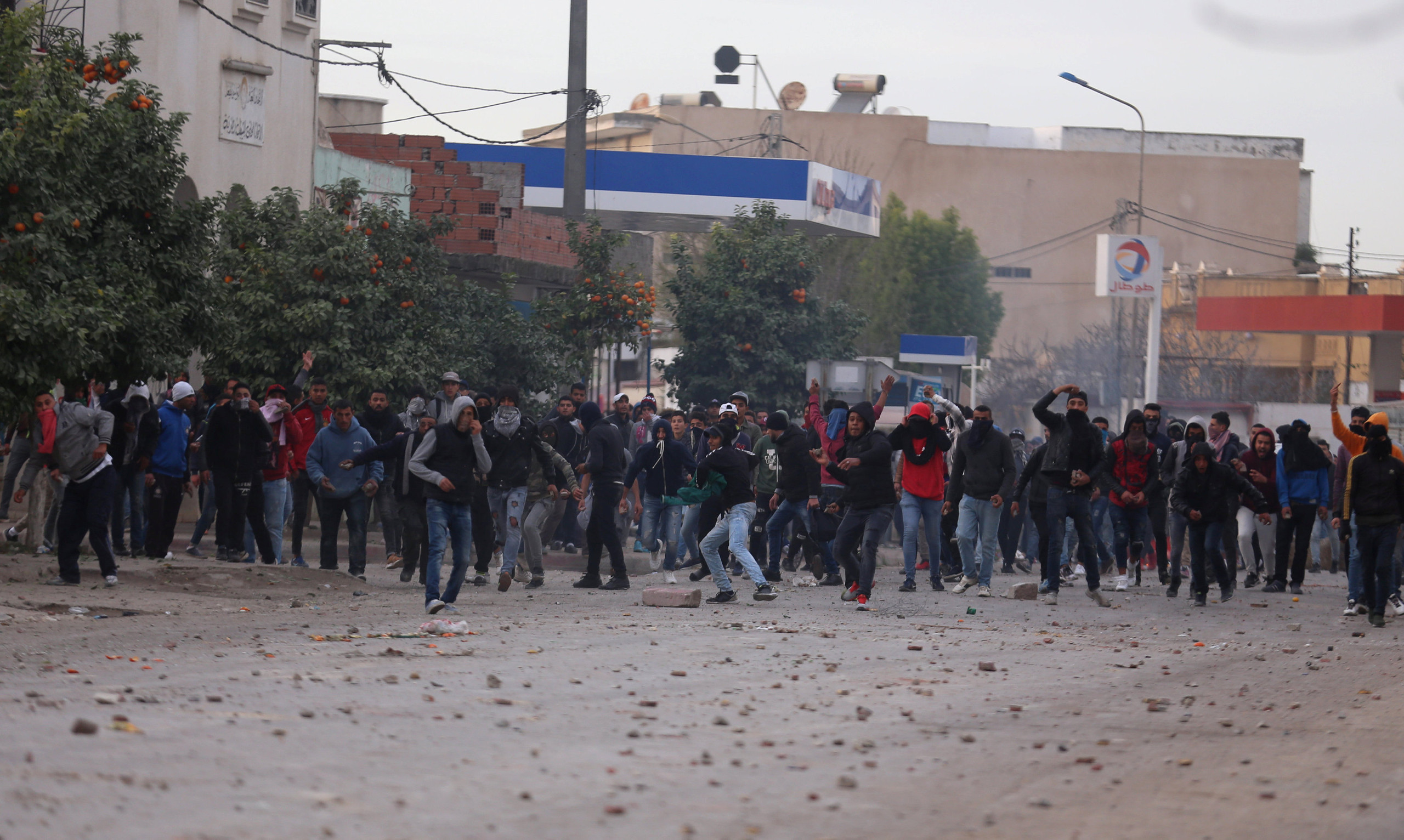 Protesters throw stones during demonstrations against rising prices and tax increases, in Tebourba, Tunisia, January 9, 2018. REUTERS/Zoubeir Souissi