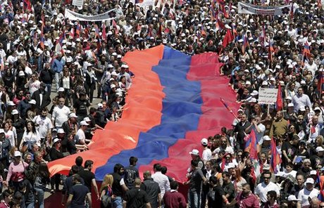 Thousands of Lebanese of Armenian descent, holding banners and a giant Armenian flag, march to mark the 100th anniversary of the mass killings of Armenians by Ottoman Turks around the time of World War I, in Antelias, north of Beirut, Lebanon, Friday, April 24, 2015. Historians estimate up to 1.5 million Armenians were killed, an event widely viewed by genocide scholars as the first genocide of the 20th century. Turkey, however, denies the deaths constituted genocide, saying the toll has been inflated and that those killed were victims of civil war and unrest. (AP Photo/Bilal Hussein)