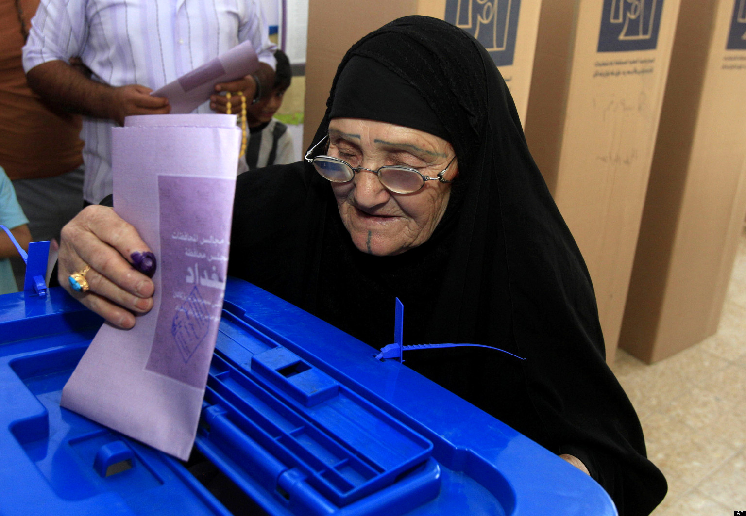 An elderly Iraqi woman casts her ballot at a polling center during the country's provincial elections in Baghdad, Iraq, Saturday, April 20, 2013. Polls opened amid tight security in Iraq on Saturday for regional elections in the country's first vote since the U.S. military withdrawal, marking an important test of the country's stability. (AP Photo/Karim Kadim)