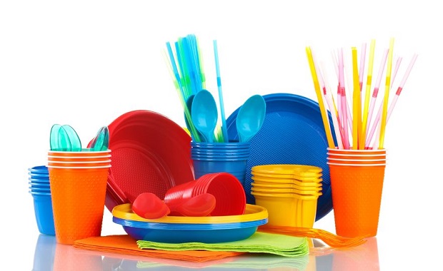 11225739 - bright plastic tableware and napkins isolated on white