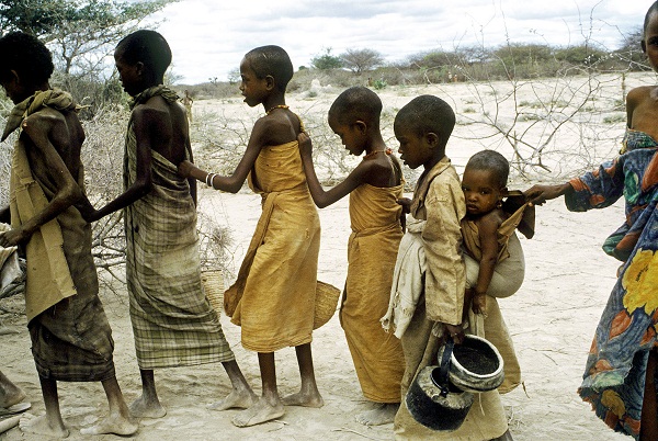 August 1992 - Berdale, Somalia - During the height of the Somalia famine, starving children line up to receive food at a feeding station in Berdale. More than 300,000 people died of hunger.
Phot Credit: ANDREW HOLBROOKE/CORBIS