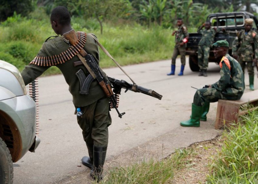 Armed Forces of the Democratic Republic of the Congo (FARDC) soldiers rest next to a road after Islamist rebel group called the Allied Democratic Forces (ADF) attacked area around Mukoko village, North Kivu province of Democratic Republic of Congo, December 11, 2018. REUTERS/Goran Tomasevic