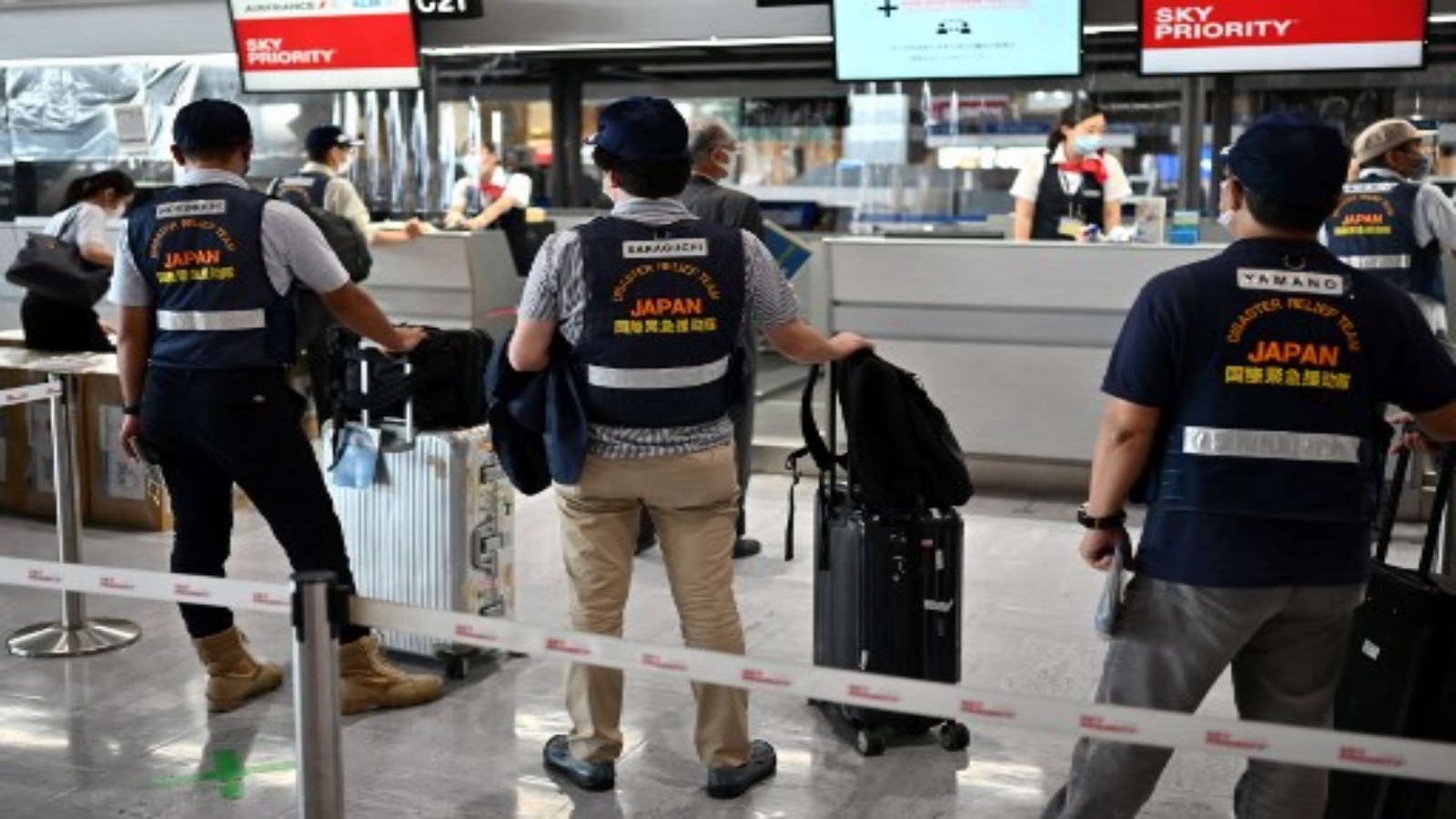 Ecosystem and environmental experts from the Japan International Cooperation Agency (JICA) check their bags as they prepare to leave for Mauritius, at the Narita International Airport in Narita, Chiba Prefecture on August 19, 2020. - Japan is sending a second team of experts to help clean up more than 1,000 tonnes of oil that leaked from a Japanese-owned bulk carrier into pristine waters off the coast of Mauritius. (Photo by CHARLY TRIBALLEAU / AFP)