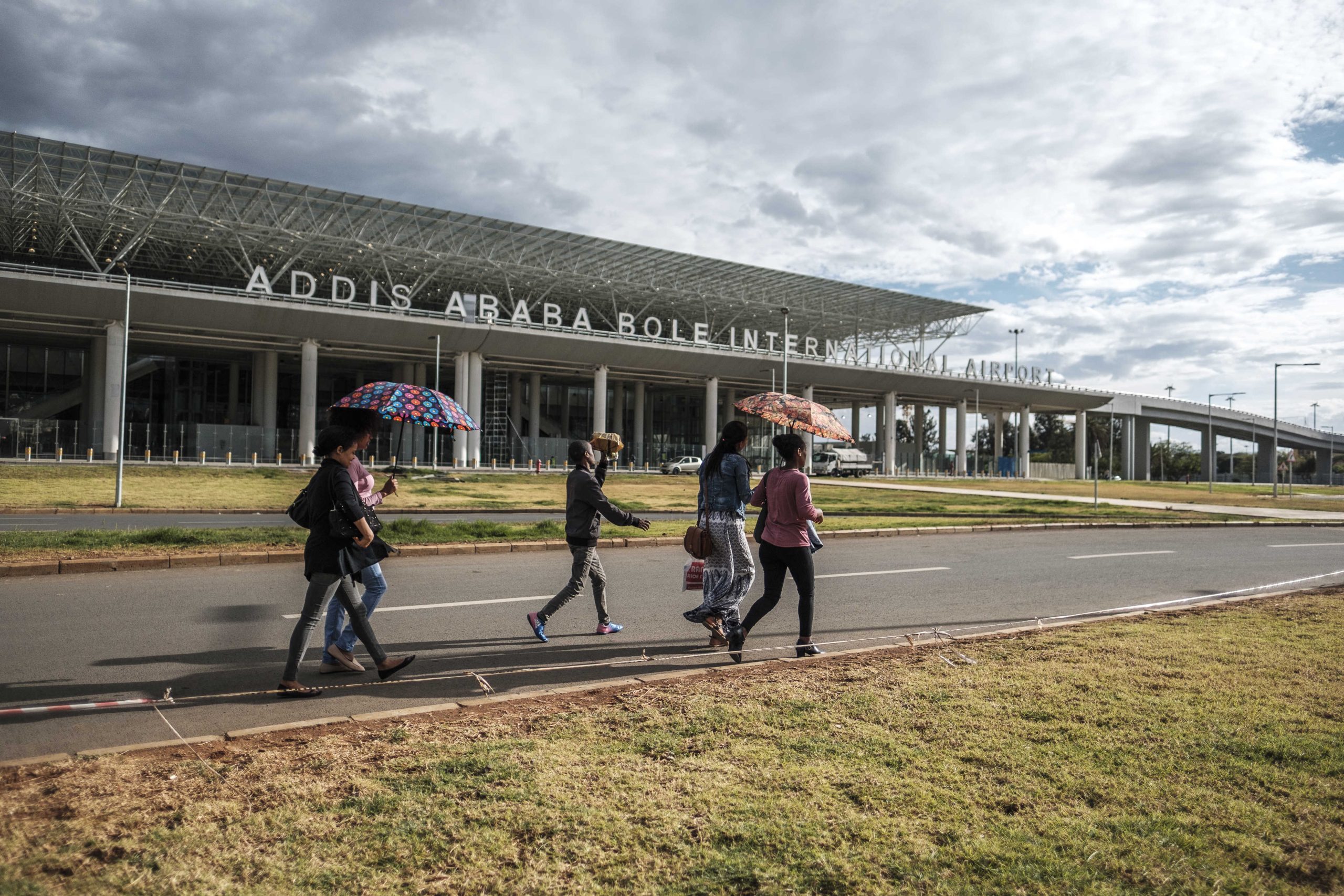 People walk in front of the Bole International Airport, in Addis Ababa, on March 17, 2020. (Photo by EDUARDO SOTERAS / AFP)