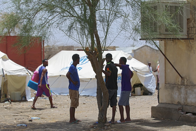 Ethiopian soldiers stand in the shade of a tree at the Um Gargour refugee camp in eastern Sudan where they have found interim sanctuary, on May 23, 2021. - Peacekeepers formerly posted to Darfur and hailing from Ethiopia's conflict-hit Tigray region are requesting asylum in Sudan for fear of "torture" and "ethnic cleansing" back home, they have told AFP. (Photo by Hussein ERY / AFP)