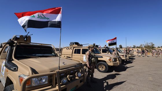 Iraqi soldiers from the new 'desert battalion' special forces stand next to military vehicles as the take part in a graduation ceremony, after months of training by the French military, at the Ain al-Asad air base in Anbar west of Baghdad on February 29, 2024. (Photo by Ahmad AL-RUBAYE / AFP) (Photo by AHMAD AL-RUBAYE/AFP via Getty Images)