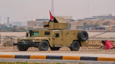 An Iraqi army armoured humvee vehicle is deployed near the banks of the Tigris River to protect the U.S. Embassy fortified "Green Zone" in Baghdad, Saturday, March 14, 2026. (AP Photo/Hadi Mizban)