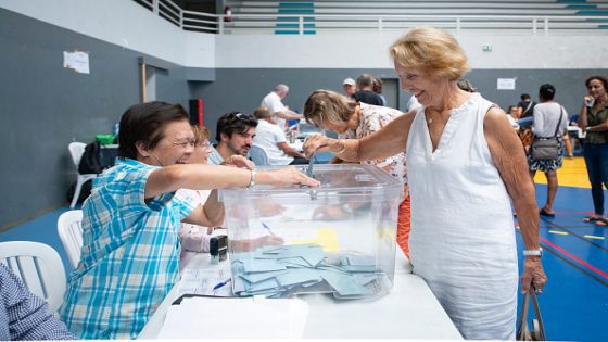 A voter casts her ballot during the first round of France's 2026 municipal elections at the Anse Vata Sports Arena in Noumea, in the French overseas collectivity of New Caledonia, on March 15, 2026. (Photo by Delphine MAYEUR / AFP via Getty Images)
