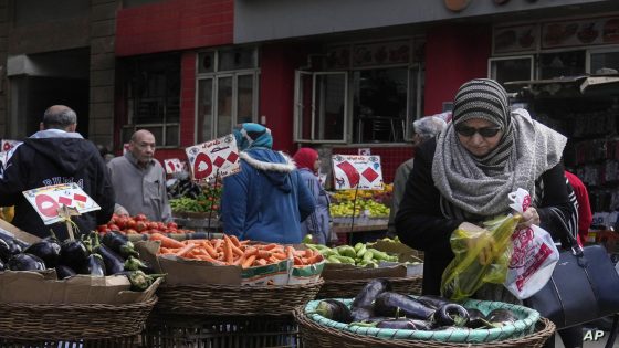 Egyptians buy vegetables at a popular market in Cairo, Egypt, Thursday, Jan. 12, 2023. Egypt continues to battle surging inflation amid a dramatic slide of its currency as many Egyptians struggle with price hikes, the country's statistics bureau said. (AP Photo/Amr Nabil)