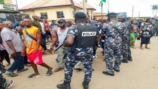 People gather as policemen arrive at the scene of an attack, the morning after gunmen killed multiple people in an overnight attack in Angwan Rukuba, Jos North, Plateau State, Nigeria March 30, 2026. REUTERS/Stringer