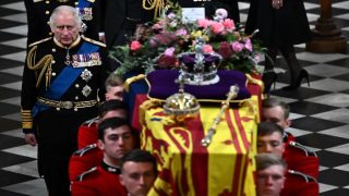 Britain's King Charles III (L) walks beside The coffin of Queen Elizabeth II, draped in a Royal Standard and adorned with the Imperial State Crown and the Sovereign's orb and sceptre as it leaves the Abbey at the State Funeral Service for Britain's Queen Elizabeth II, at Westminster Abbey in London on September 19, 2022. - Leaders from around the world will attend the state funeral of Queen Elizabeth II. The country's longest-serving monarch, who died aged 96 after 70 years on the throne, will be honoured with a state funeral on Monday morning at Westminster Abbey. (Photo by Ben Stansall / POOL / AFP)