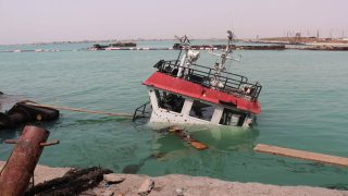 The navigation bridge of a sunken vessel is all that is seen at the surface of the water in the Port of Mokha the day after an attack by the Houthis on the city Mokha, held by Yemen's internationally recognised, Aden-based government on August 10, 2026. Strikes by Iran-backed Houthi rebels on August 9, 2026, killed at least 11 people, a medical source in the Yemeni port city of Mokha told AFP, after an earlier drone salvo targeted a Saudi oil refinery on the Red Sea coast. A years-long truce in Yemen's civil war between the Houthis and the Saudi-backed, internationally recognised government appeared to collapse last month as fighting between regional allies of the United States and Iran flared. (Photo by Khaled ZIAD / AFP) /