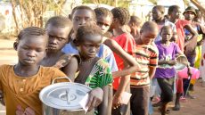 SOUTHSUDANCONFLICT South Sudan refugee children line up at the reception centre in Kakuma to receive porridge that is served for breakfast. They fled fighting in South Sudan. As at January, about 5,000 children had arrived at the Kakuma refugee camp most unaccompanied. Summary: As of 30 January 2014, the number of refugees arriving at the Kakuma refugee camp has reached about 13,000. Daily arrivals are averaging between 300-400, arriving through the border point of Nadapal. They temporarily stay at the reception centre for a few days as they await resettlement to the new refugee camp site provided by the Kenya Government. Different aid agencies including World Vision are supporting with humanitarian assistance. World Vision is providing food assistance for the daily arrivals. The new arrivals are flocking the World Vision food distribution site to register for the food rations.